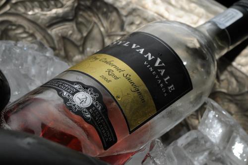 a bottle of wine sitting on top of ice at The Devon Valley Hotel in Stellenbosch