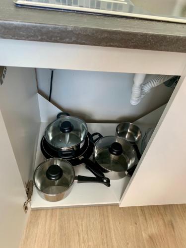 a couple of pots and pans in a kitchen drawer at Apartman Skupovka in Most