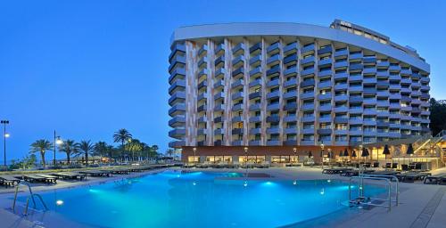 a hotel with a swimming pool in front of a building at Melia Costa del Sol in Torremolinos