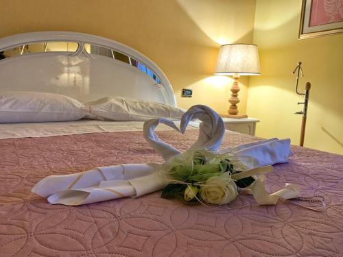 a wedding dress and flowers on a bed at Il Frutteto in Assergi