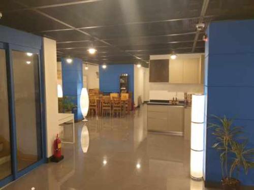a large room with a kitchen and a dining room at Appletree Hotel Pohang in Pohang