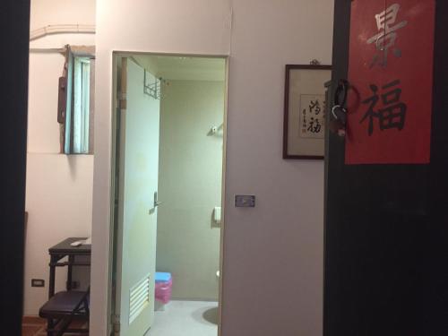 an open door to a bathroom with a mirror at 來喜樓-珠山82號民宿 in Jincheng