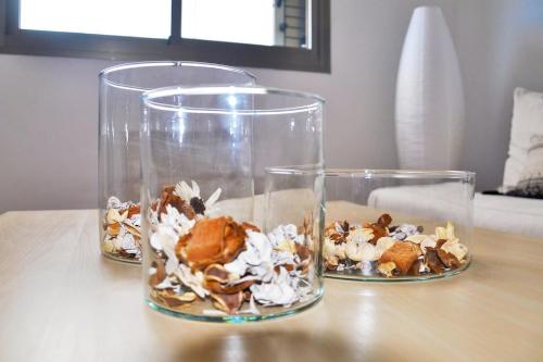 two glass vases with food in them on a table at Casa Lucía in Vecindario
