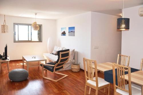 a living room with a table and a dining room at Casa Gabriel in Vecindario