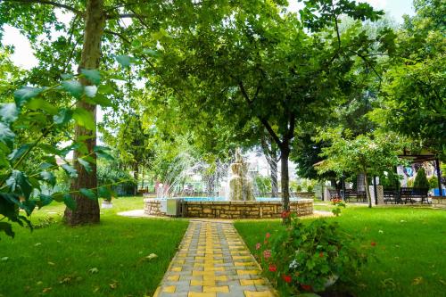 a park with a fountain in the middle of a park at Krikonis Hotel in Ioannina