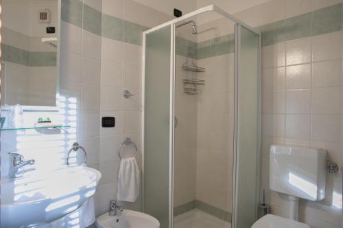 a bathroom with a shower and a sink and a toilet at HOTEL DEL CORSO in Borgomanero