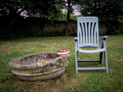 a chair and a pair of shoes sitting in a yard at Casa Rural Ortulane in Urduliz