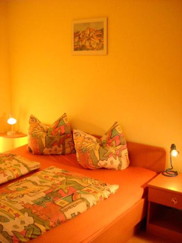 a bedroom with a bed and two pillows on it at Appartments Am Wiesenrand in Nova Ponente
