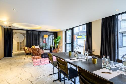 a dining room with a table and chairs at PREMIER SUITES Antwerp in Antwerp