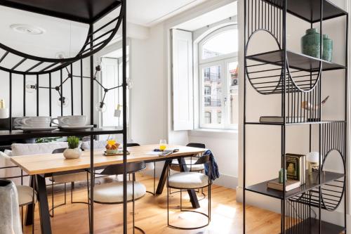 a kitchen and dining room with a table and chairs at ALTIDO Downtown Bliss Apartments in Lisbon