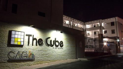 a sign on the side of a building at night at CAG The Cube Rivonia in Johannesburg