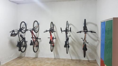 a wall with a bunch of bikes hanging from it at Hotel El Carmen in Puente Genil