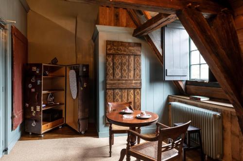 a kitchen with a table and chairs in a room at Hotel Beijers in Utrecht
