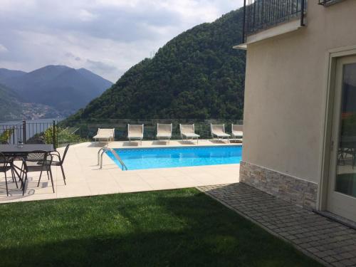 a swimming pool with a view of a mountain at Villa Lilla in Argegno
