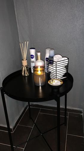 a black table with a candle and other items on it at Apartmány Klárka in Rokytnice nad Jizerou