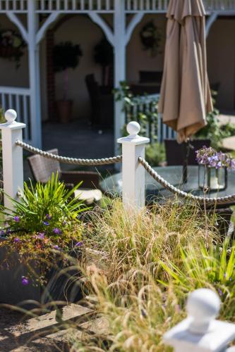 a porch with a chain fence and an umbrella at Beachlands Hotel in Weston-super-Mare