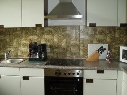 a kitchen counter with a stove and a sink at Ferienwohnung Salker in Daun