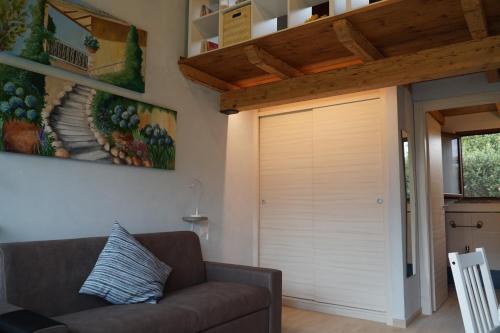 a garage door in a living room with a couch at Villa Giuseppe Bernabei Guest House in Marino