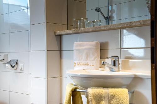 a bathroom with a sink and a mirror at Appartements Monuth in Bad Hofgastein