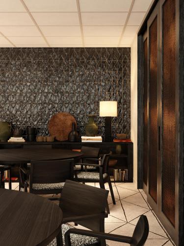 a dining room with tables and chairs and a black wall at Radisson Blu Hotel Casablanca City Center in Casablanca