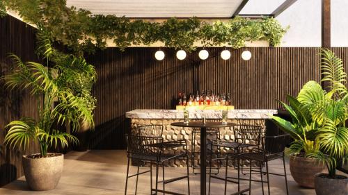 a bar with chairs and a table with drinks at Radisson Blu Hotel Casablanca City Center in Casablanca