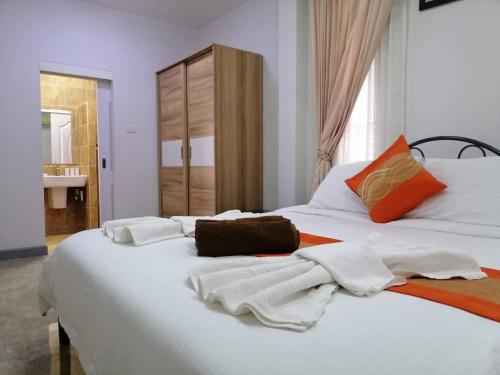 a large white bed with towels on top of it at Bann Mountain View in Ao Nang Beach