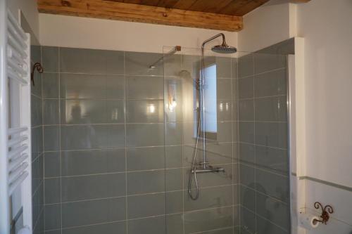 a bathroom with a shower with green tile at Villa Giuseppe Bernabei Guest House in Marino