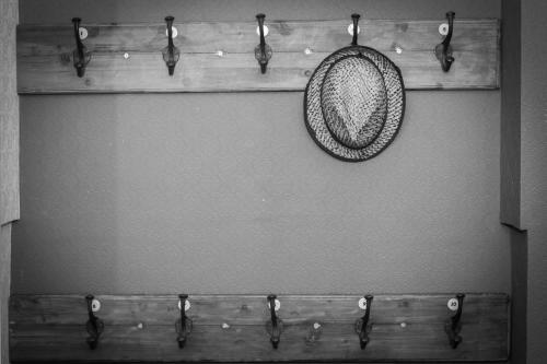 a hat is hanging on a wooden shelf at Beachlands Hotel in Weston-super-Mare
