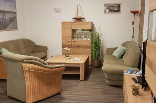 a living room with two couches and a coffee table at Stolpseeblick in Himmelpfort