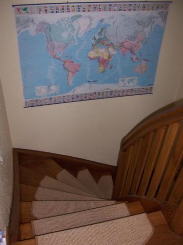 a map of the world hanging on a wall at Haus am Roseneck in Lüneburg