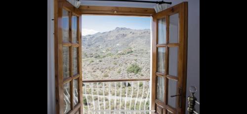 an open window with a view of a mountain at Villa with HEATED Pool and Amazing Mountain and Sea Views No Young Groups Allowed in Mojácar