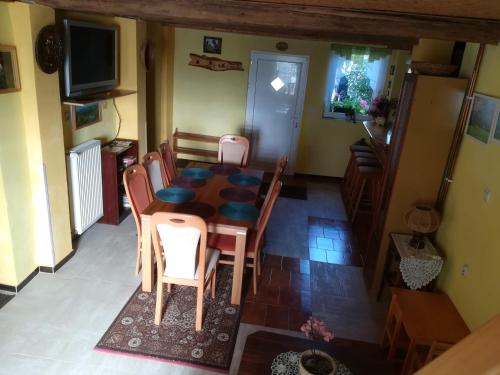 a dining room with a table and chairs and a television at Private Světluška in Poběžovice