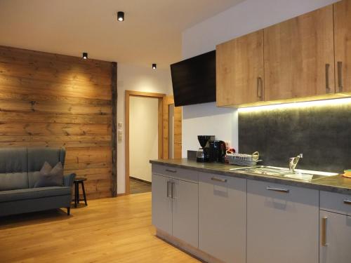 a kitchen with a sink and a counter top at Apartment Haus Dahoam in Alpbach