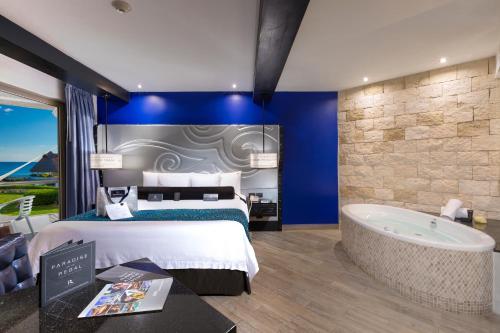 a hotel room with a bed and a tub at Hard Rock Hotel Riviera Maya - Heaven Adults Only - All Inclusive in Puerto Aventuras