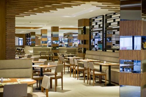 a restaurant with tables and chairs in a room at Amphoras Beach - Ultra All Inclusive in Sharm El Sheikh