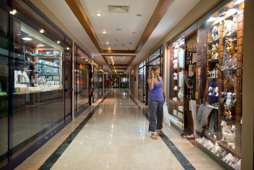 a woman talking on a cell phone in a shopping mall at Amphoras Beach - Ultra All Inclusive in Sharm El Sheikh