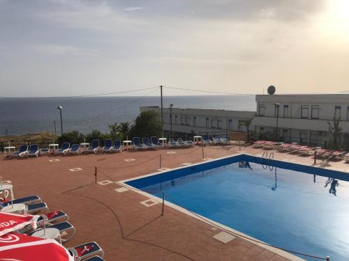 a large swimming pool in front of a building at Costa Makauda Residence in Sciacca