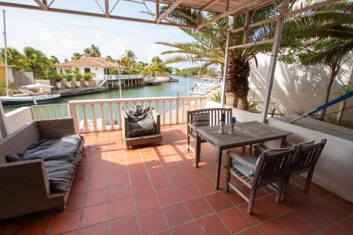 a patio with a table and chairs and a view of the water at Aqua Marina in Kralendijk
