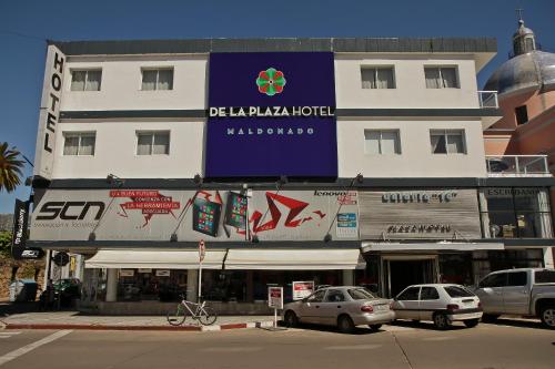 a building with a sign for a malaga hotel at De la Plaza Hotel in Maldonado