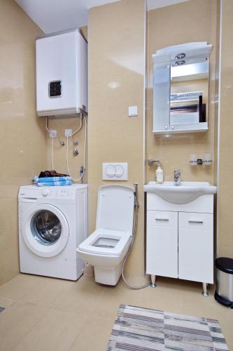 a bathroom with a washing machine and a sink at Apartment Dobrota View in Dobrota