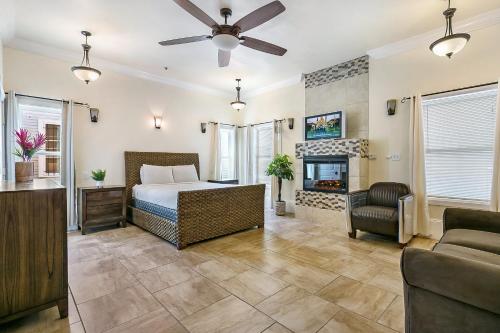 a bedroom with a bed and a fireplace at Modern 4BR City Condo 5min drive to FQ in New Orleans