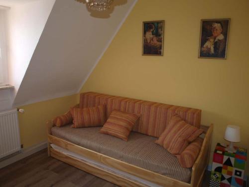 a couch with pillows sitting in a room at Ferienhaus Maria in Vinningen