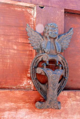 an old metal door knocker on a red door at Casa Infinidad in Moraira