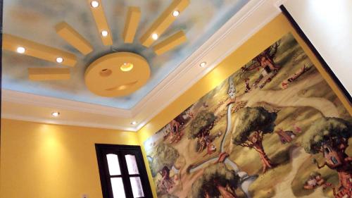 a ceiling with a painting of a sun on it at Private Room In Apartment with Sea & Hilton View in Alexandria