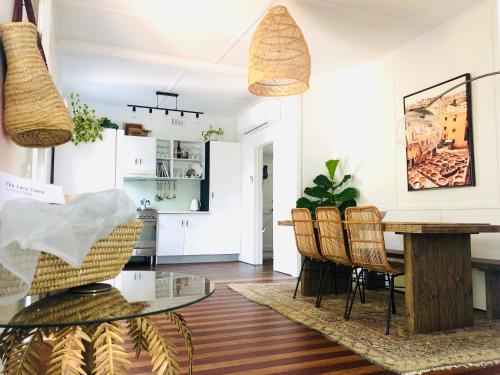 a kitchen and dining room with a table and chairs at The Lazy Llama in Evans Head