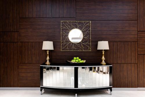 two lamps on a table with a bowl of fruit at Ramada Hotel & Suites by Wyndham Yerevan in Yerevan