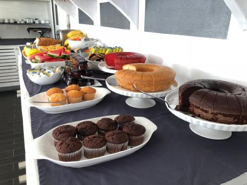 a table with different types of cakes and pastries at Albachiara Hotel - Las Terrenas in Las Terrenas