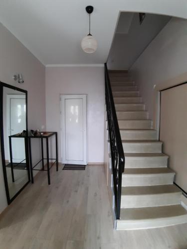 a staircase in a house with a white wall at gogoli family hotel in Tbilisi City