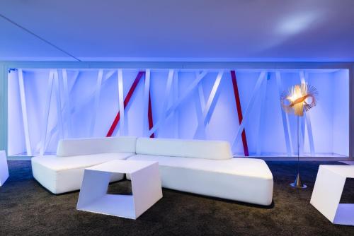 a living room with a white couch and two tables at Eurostars Palacio de Cristal in Oviedo