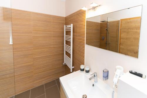 a bathroom with a sink and a mirror at Cafe Pension Rafaela in Steinbach an der Steyr